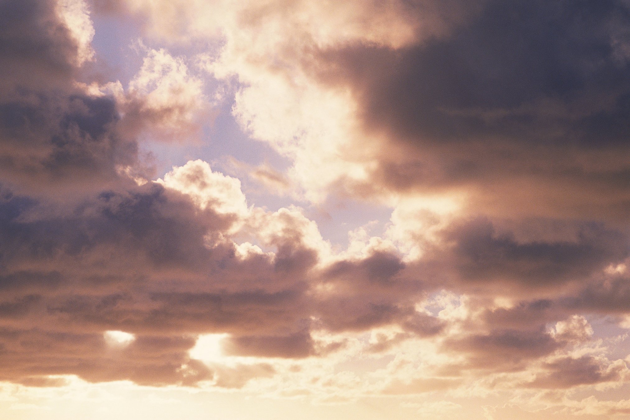 Sun shining through cumulus clouds